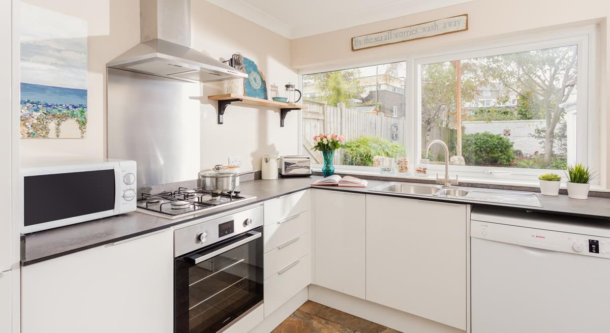 The modern and well-equipped kitchen provides the chef of the family a space to cook delicious meals.