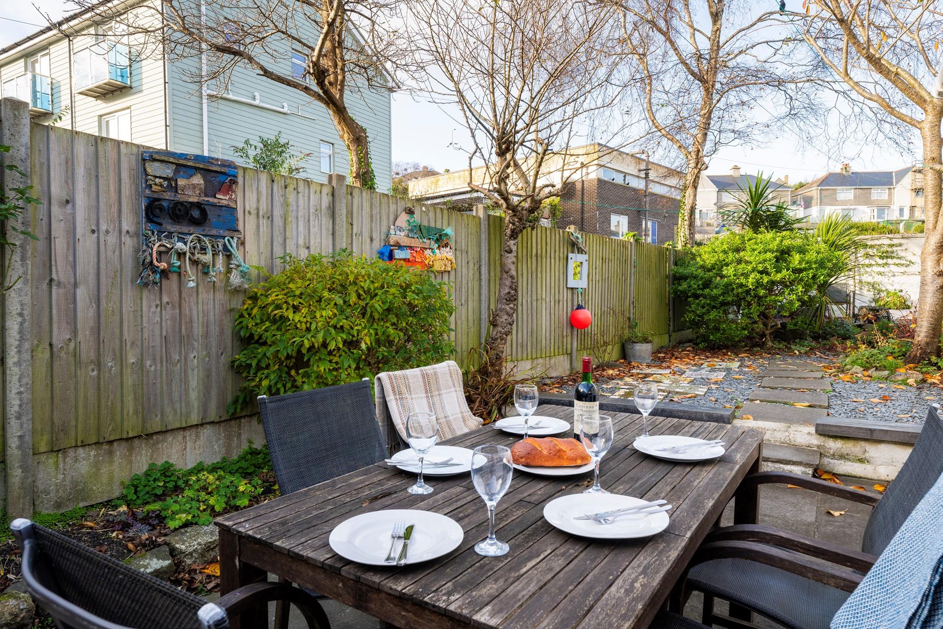 Spend your evenings indulging in al fresco meals in the sun trap garden.