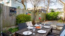 Spend your evenings indulging in al fresco meals in the sun trap garden.