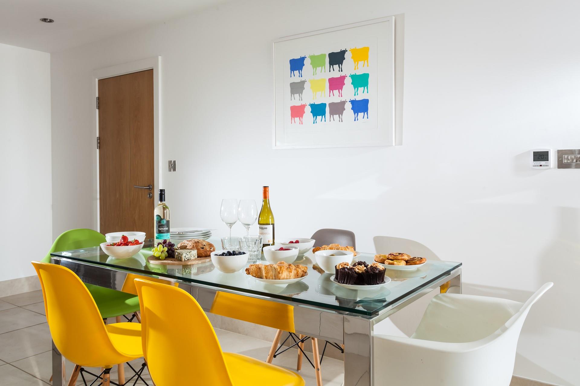 The dining table has ample space for everyone to enjoy a hearty breakfast.