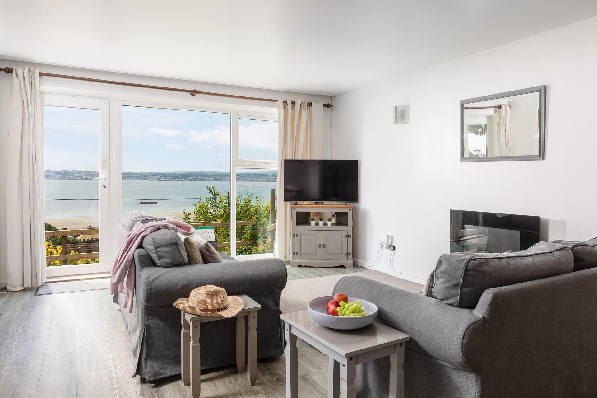 The open plan living area is a cosy space with floor-to-ceiling windows showcasing the view.