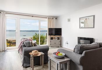 The open plan living area is a cosy space with floor-to-ceiling windows showcasing the view.