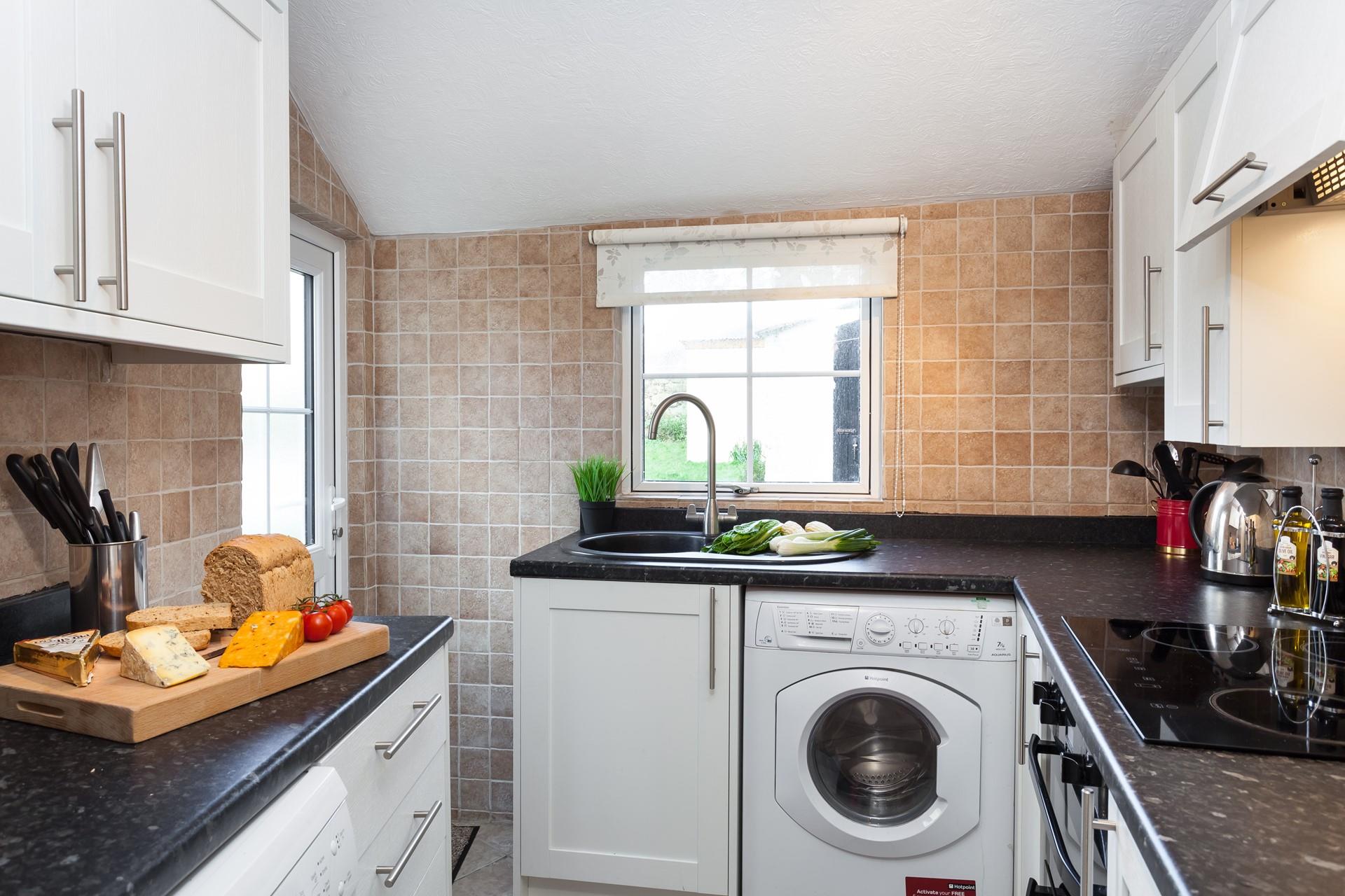 The neat kitchen leads out to the rear patio area.