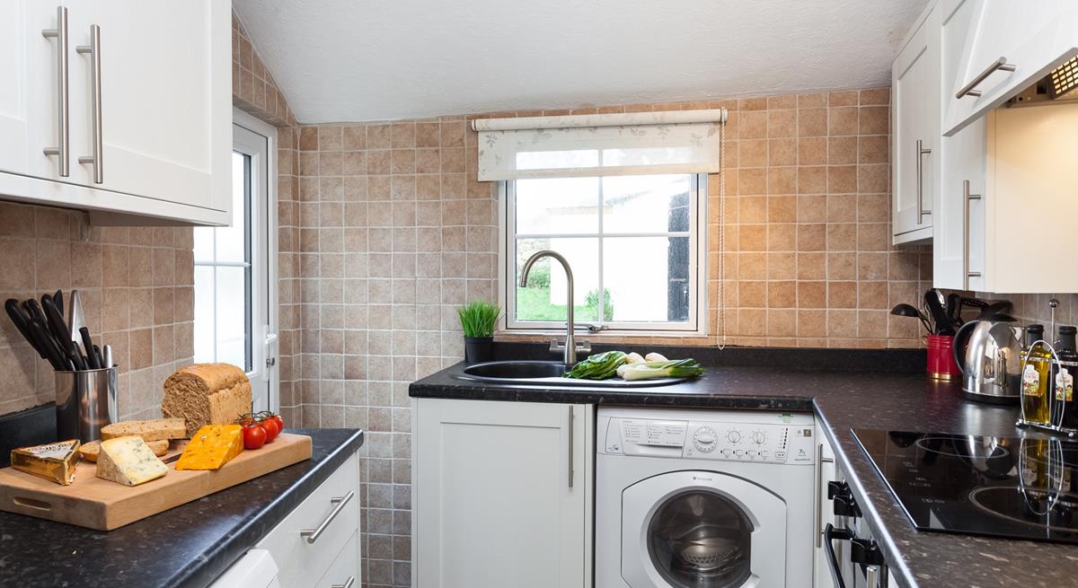 The neat kitchen leads out to the rear patio area.