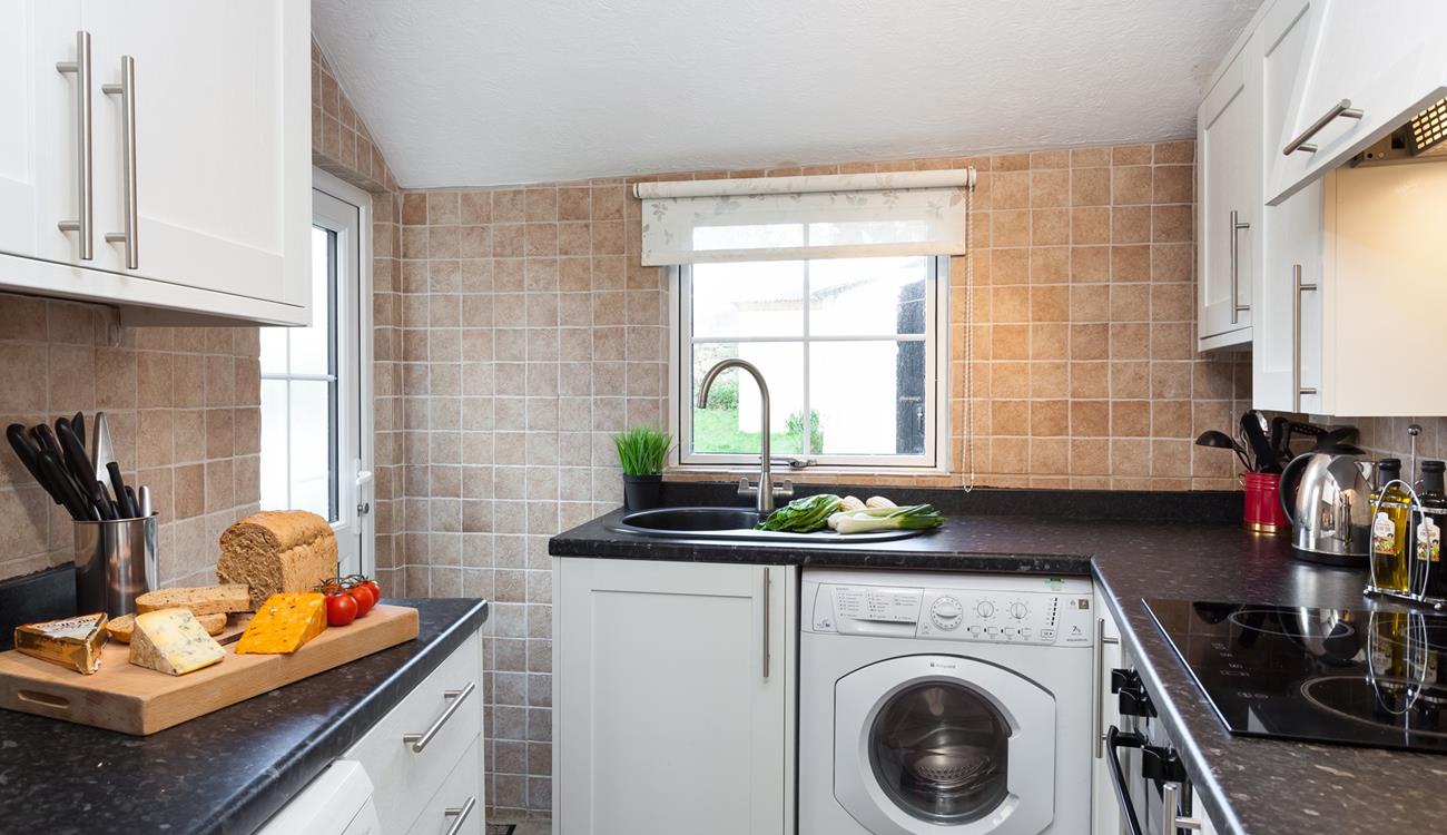 The neat kitchen leads out to the rear patio area.