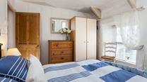 Plenty of storage for guests in the cosy, double bedroom.