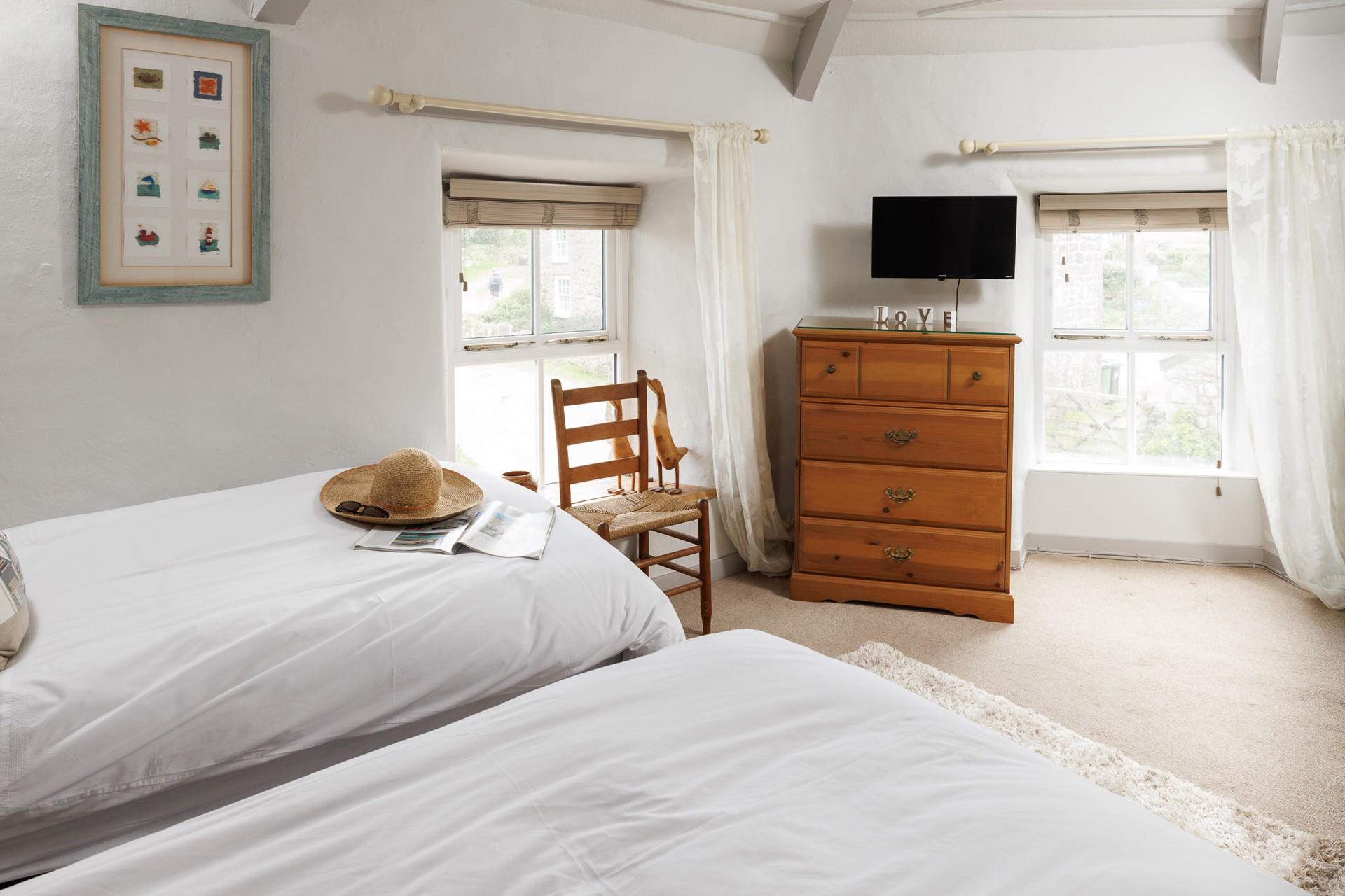 The twin bedroom is light and bright with dual aspect windows.