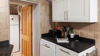 You can step from the kitchen through to the quaint patio garden.
