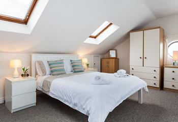 The spacious open plan main bedroom offers stunning sea views.