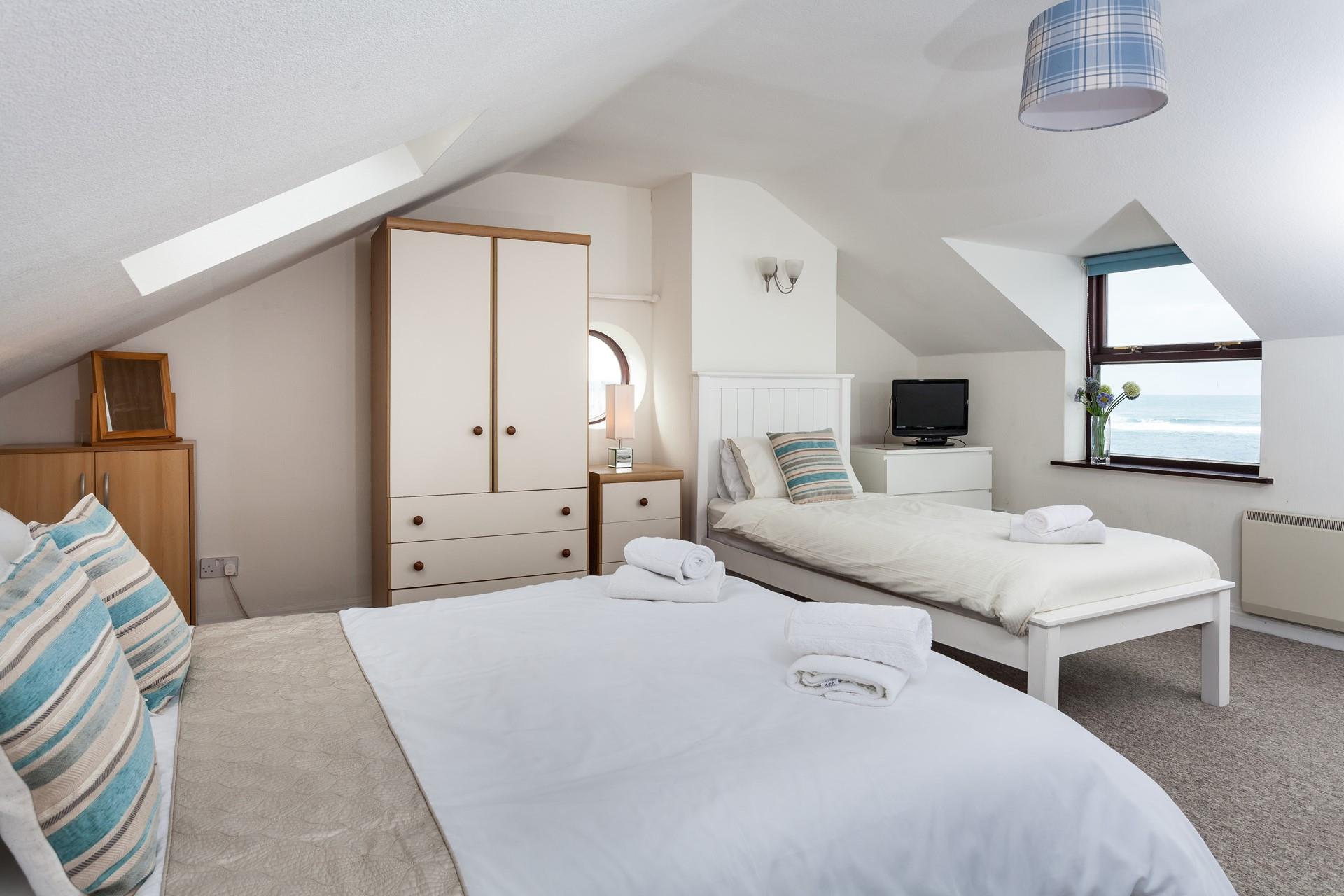 Wake up to the waves rolling onto Sennen beach.