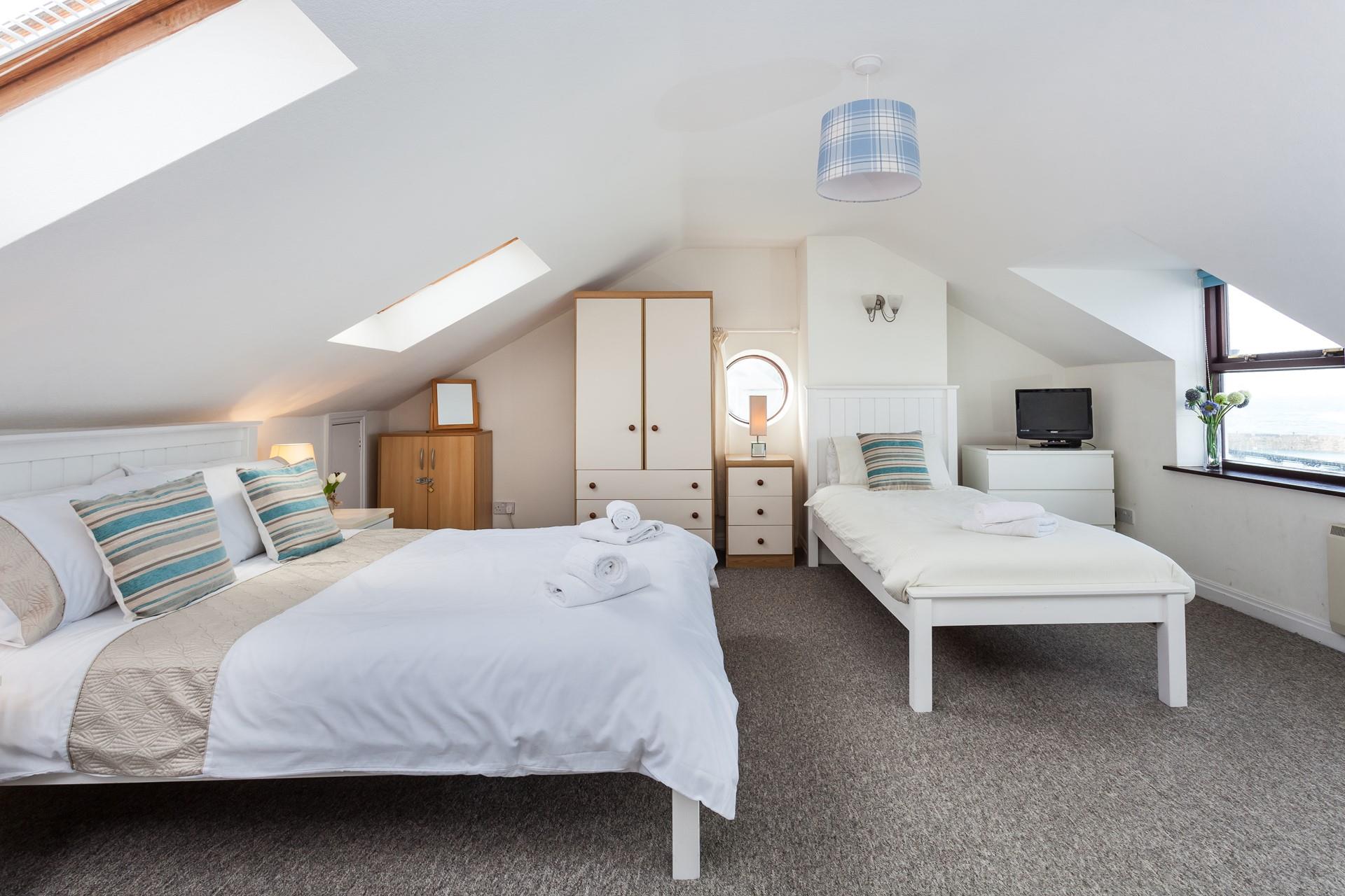 The main bedroom has a double bed and a single bed, perfect for a family holiday.