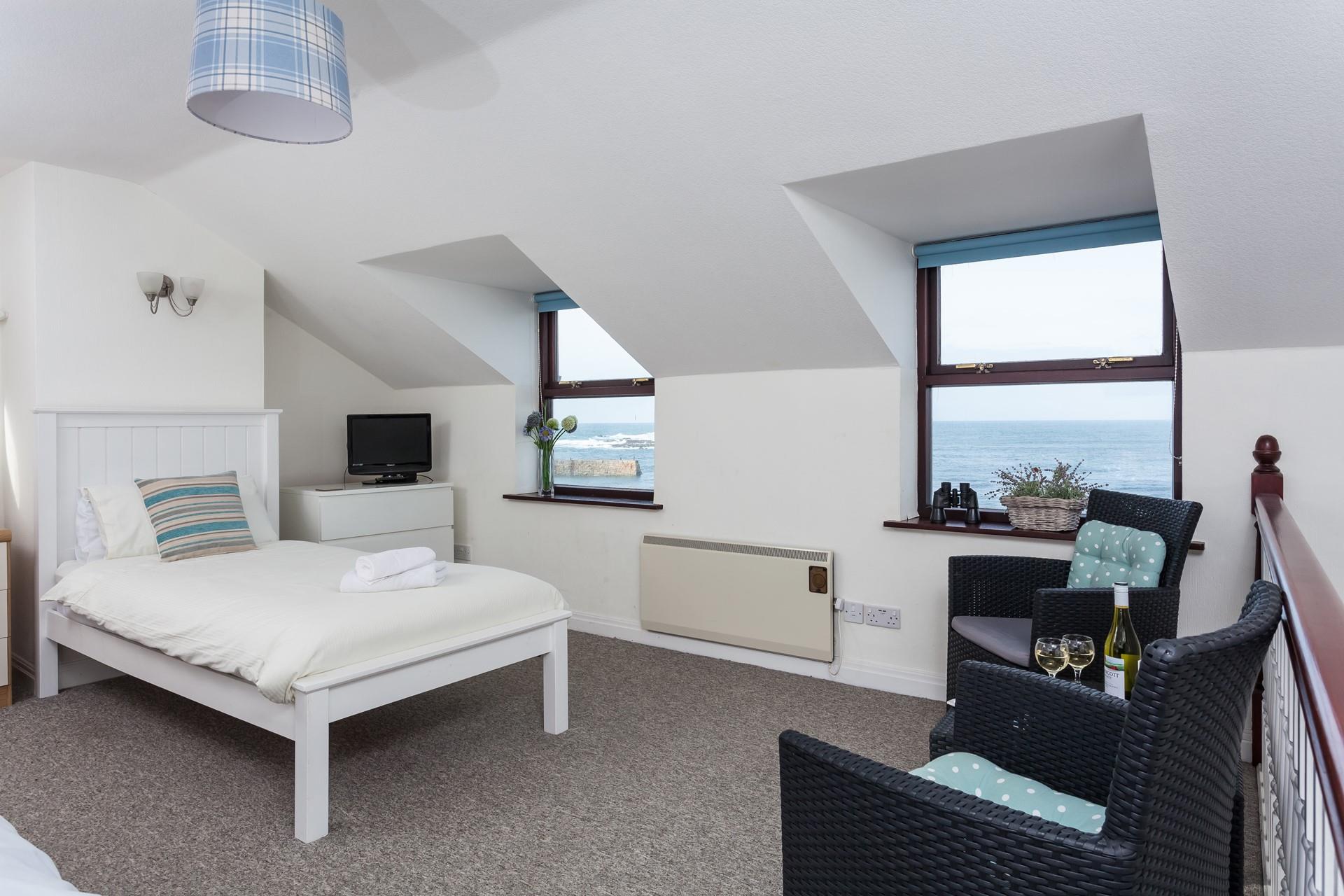 The open plan bedroom also has a seating area so you can gaze out at the sea while you enjoy your drink of choice.