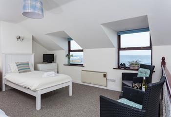 The open plan bedroom also has a seating area so you can gaze out at the sea while you enjoy your drink of choice.