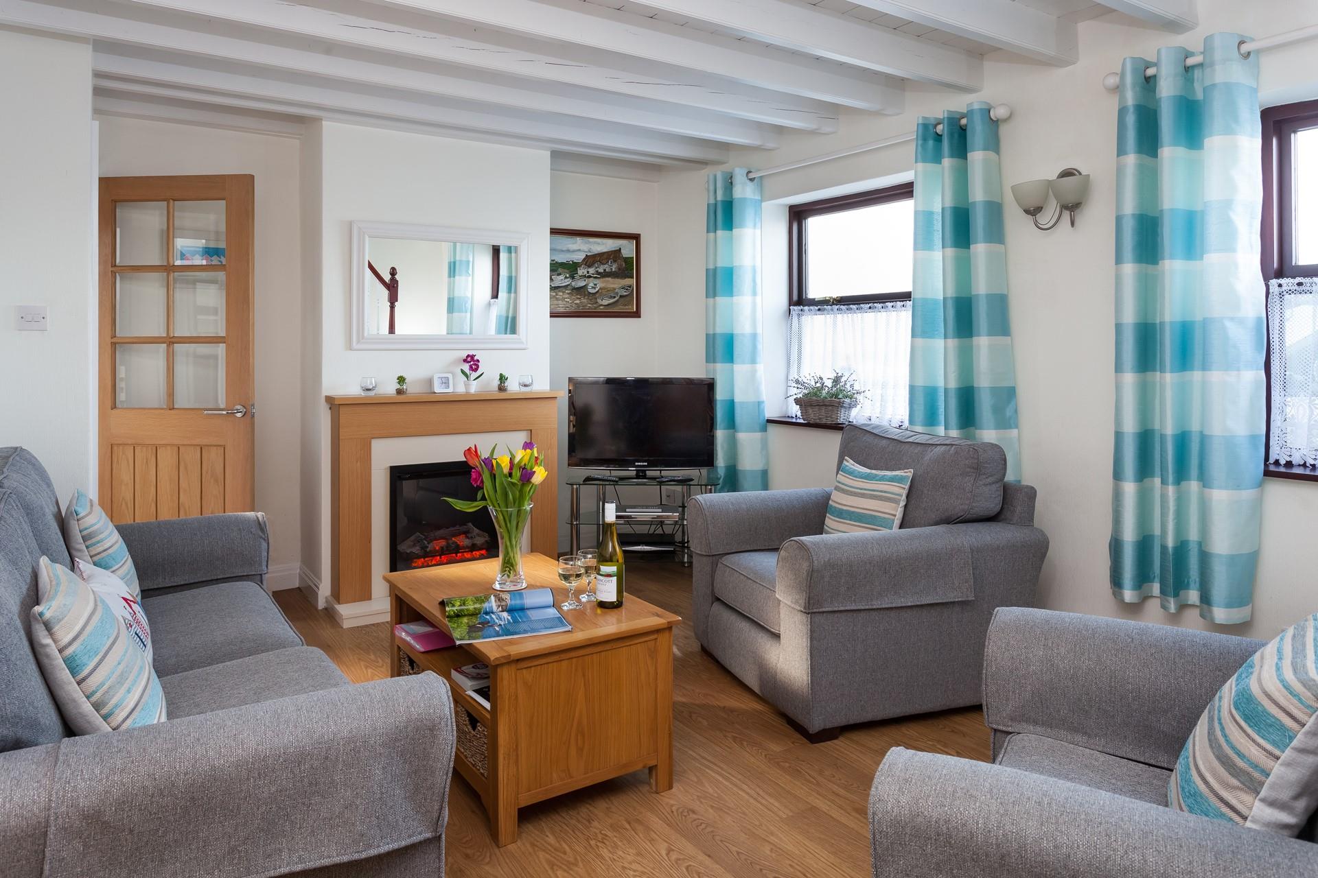 Come back after a wintery beach walk to relax in front of your woodburner effect fire.