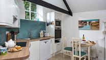 We love the exposed beams in the charming open plan living area.
