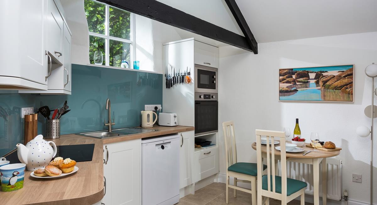 We love the exposed beams in the charming open plan living area.
