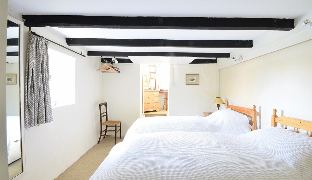 Traditional cottage features like exposed beams keep the cosy feel of this cottage.