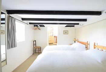 Traditional cottage features like exposed beams keep the cosy feel of this cottage.