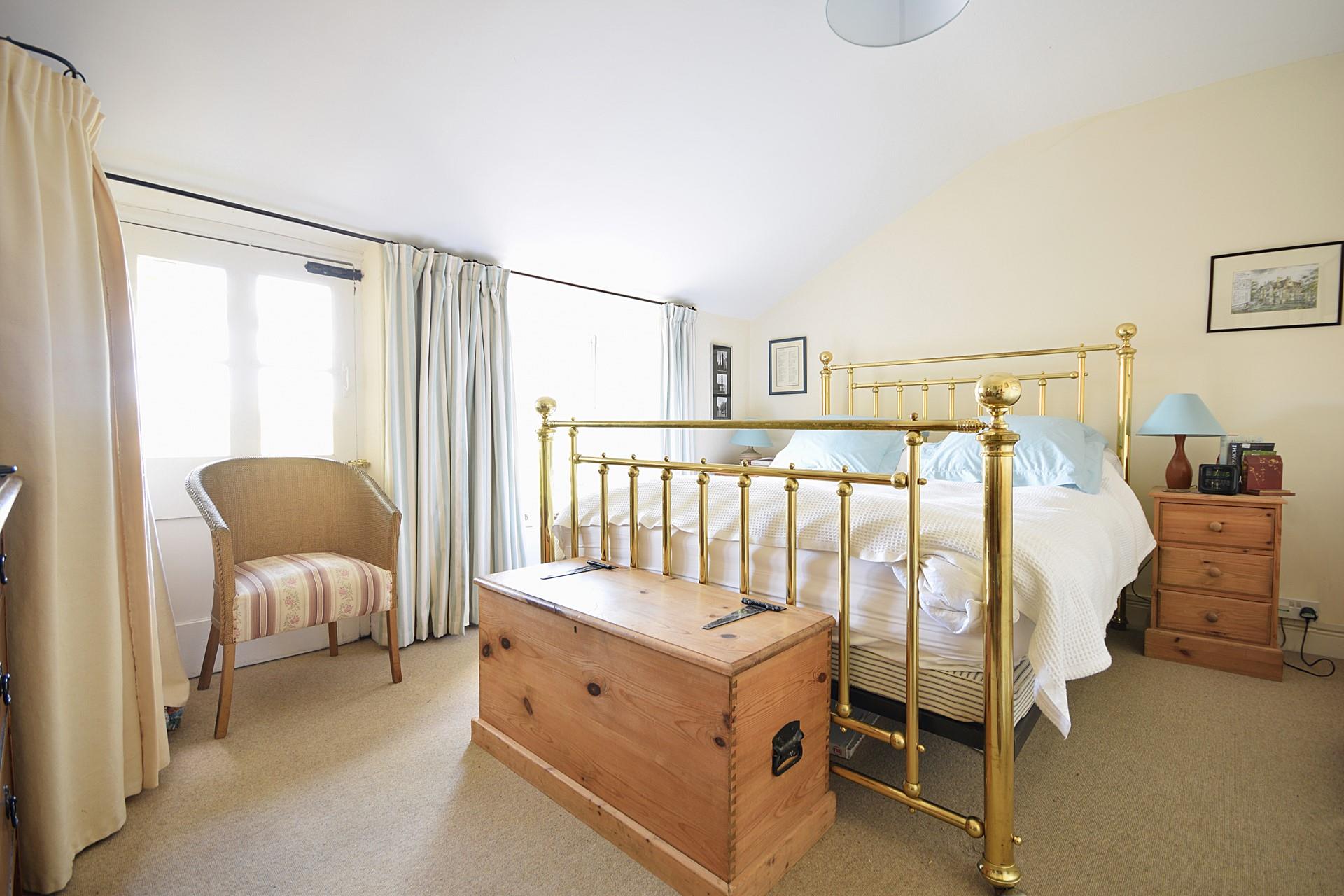 The sumptuous king size bed offers a blissful night's sleep.