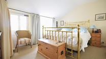 The sumptuous king size bed offers a blissful night's sleep.