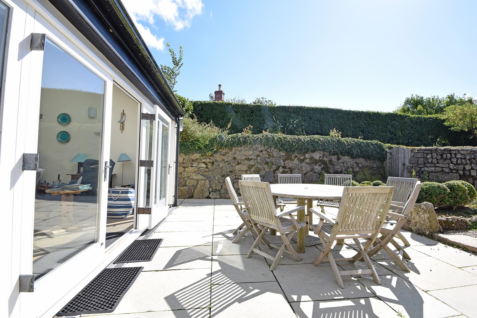 Sit outside in the sun trap garden and enjoy some al fresco dining.