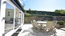 Sit outside in the sun trap garden and enjoy some al fresco dining.