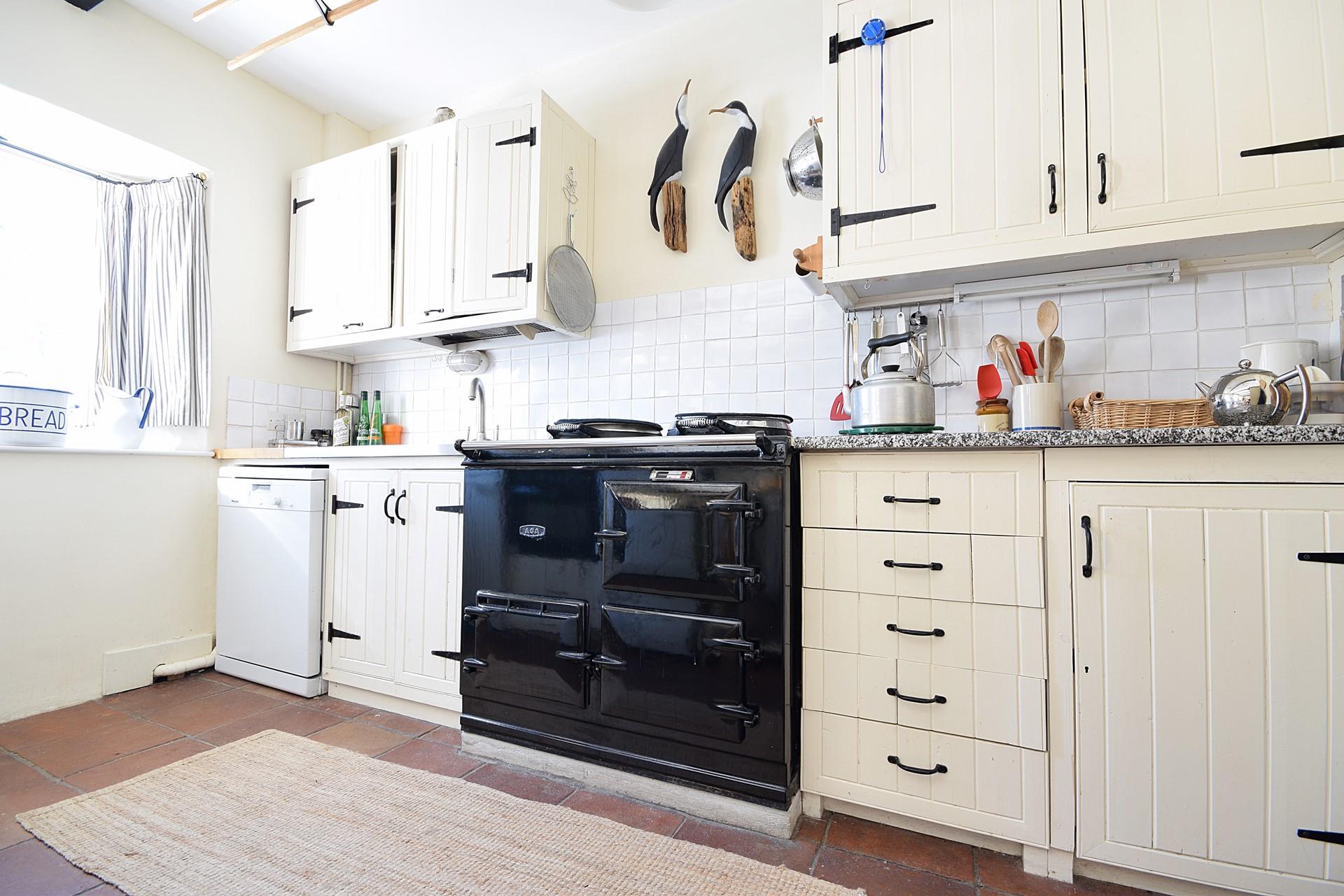 The country-style kitchen has an oil-fired Aga, perfect for cooking hearty meals.