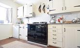 The country-style kitchen has an oil-fired Aga, perfect for cooking hearty meals. - Thumbnail Image