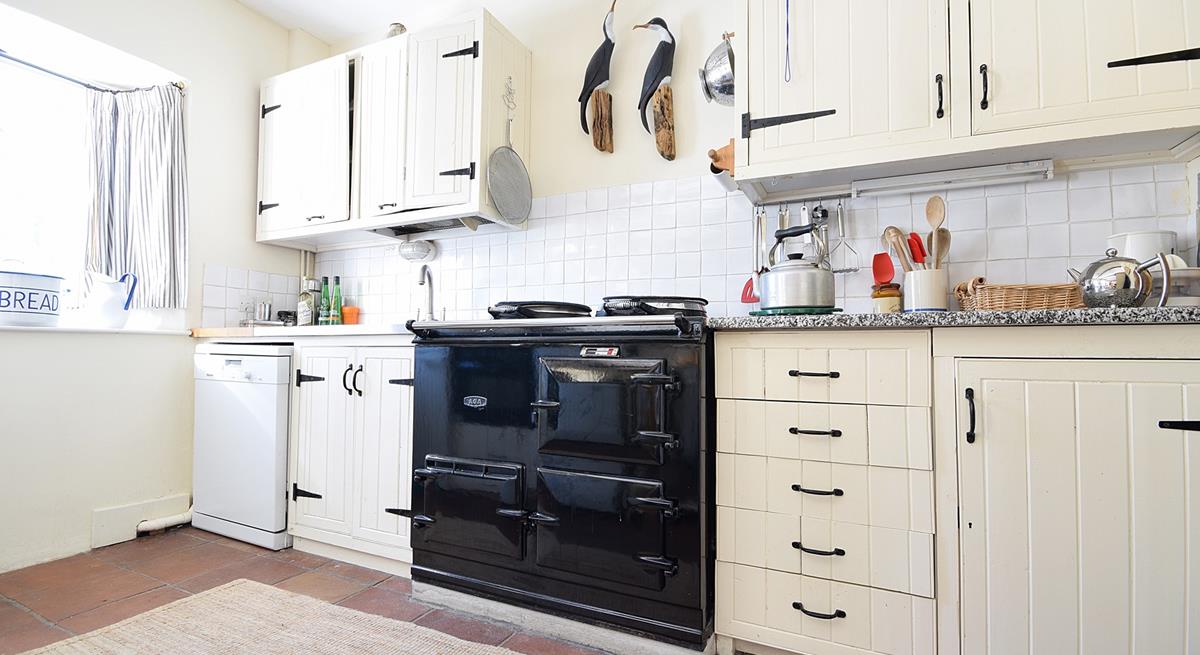 The country-style kitchen has an oil-fired Aga, perfect for cooking hearty meals.