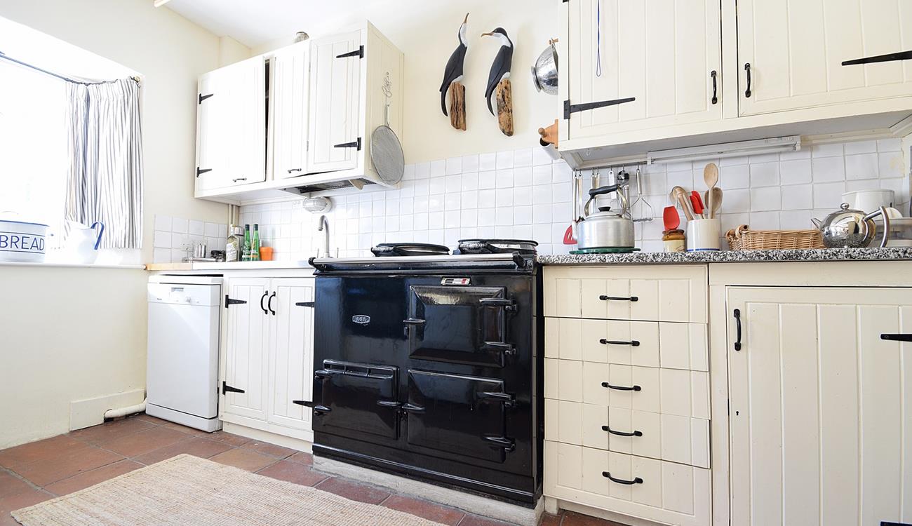 The country-style kitchen has an oil-fired Aga, perfect for cooking hearty meals.