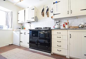 The country-style kitchen has an oil-fired Aga, perfect for cooking hearty meals.