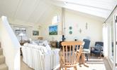 The comfortable sitting room is filled with seaside-inspired artwork. - Thumbnail Image