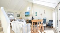 The comfortable sitting room is filled with seaside-inspired artwork.