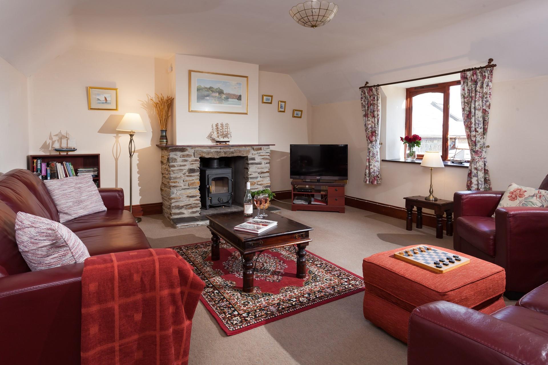 Relax in the living room with a glass of wine in hand and the fire on.