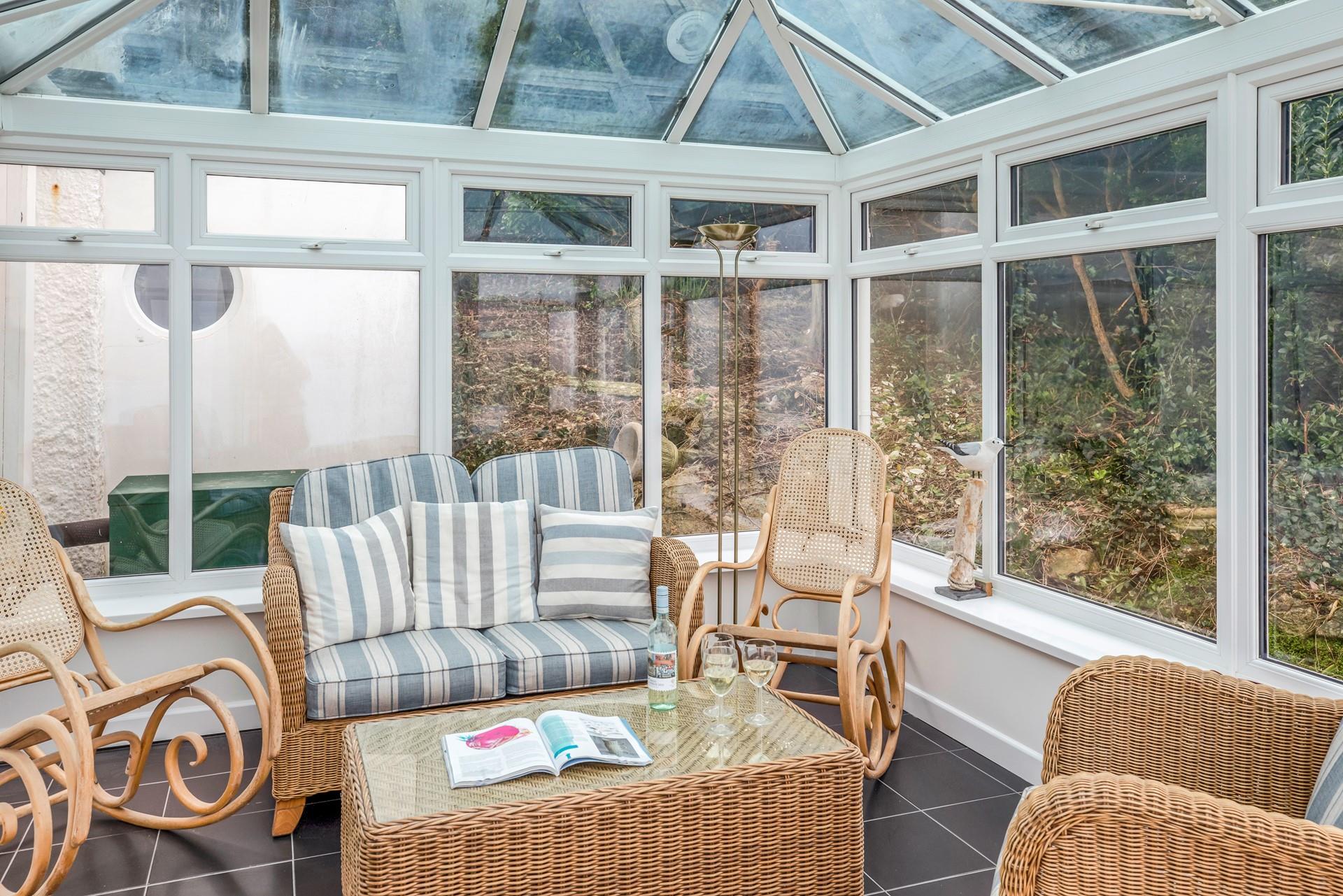 The conservatory is the ideal space to enjoy a cup of tea watching the sea.