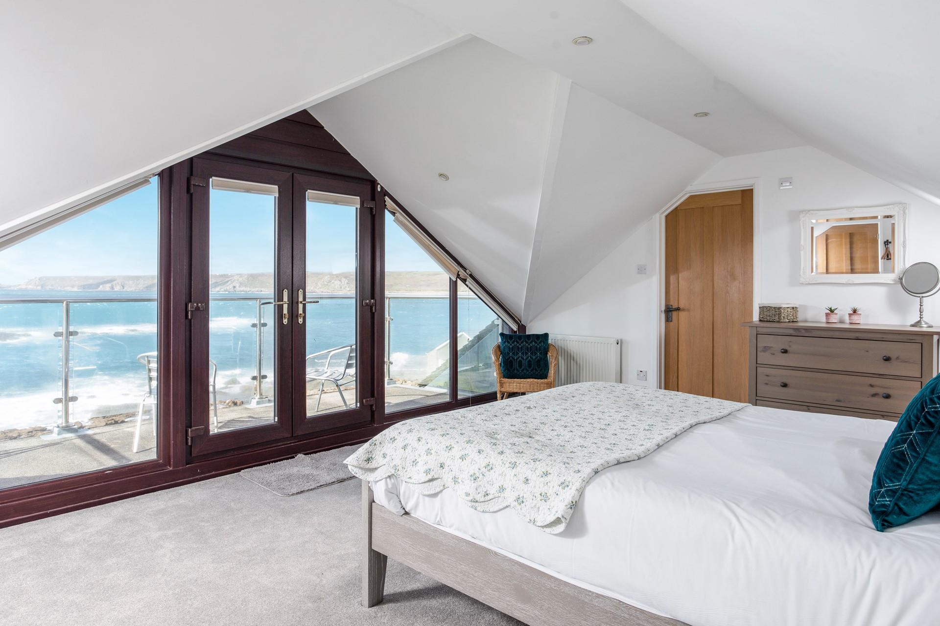 Bedroom 5 has the luxury of a balcony to enjoy each morning.