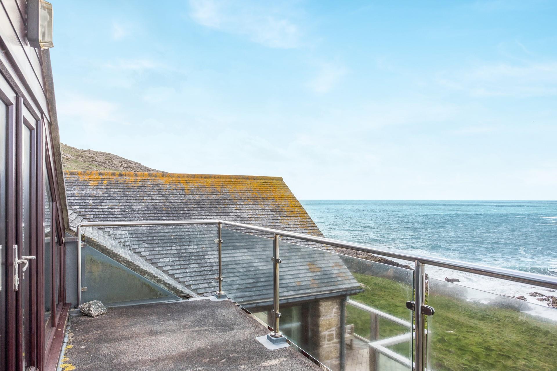 Watch the waves lap over the rocks in quaint Sennen Cove.