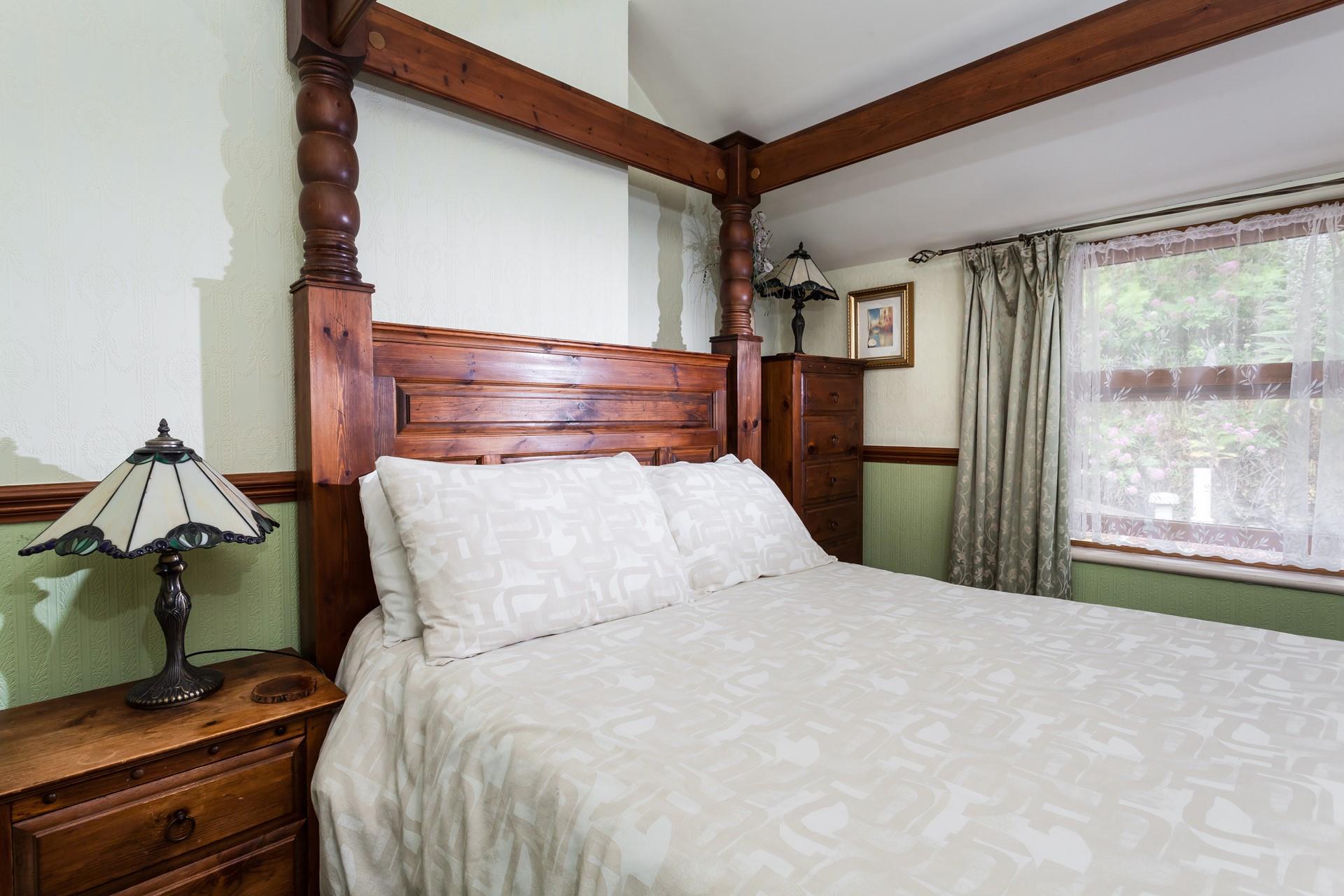 The spacious four poster bed offers a relaxing night's sleep after a day of walking on the coast path.