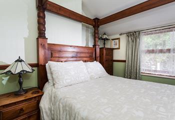 The spacious four poster bed offers a relaxing night's sleep after a day of walking on the coast path.