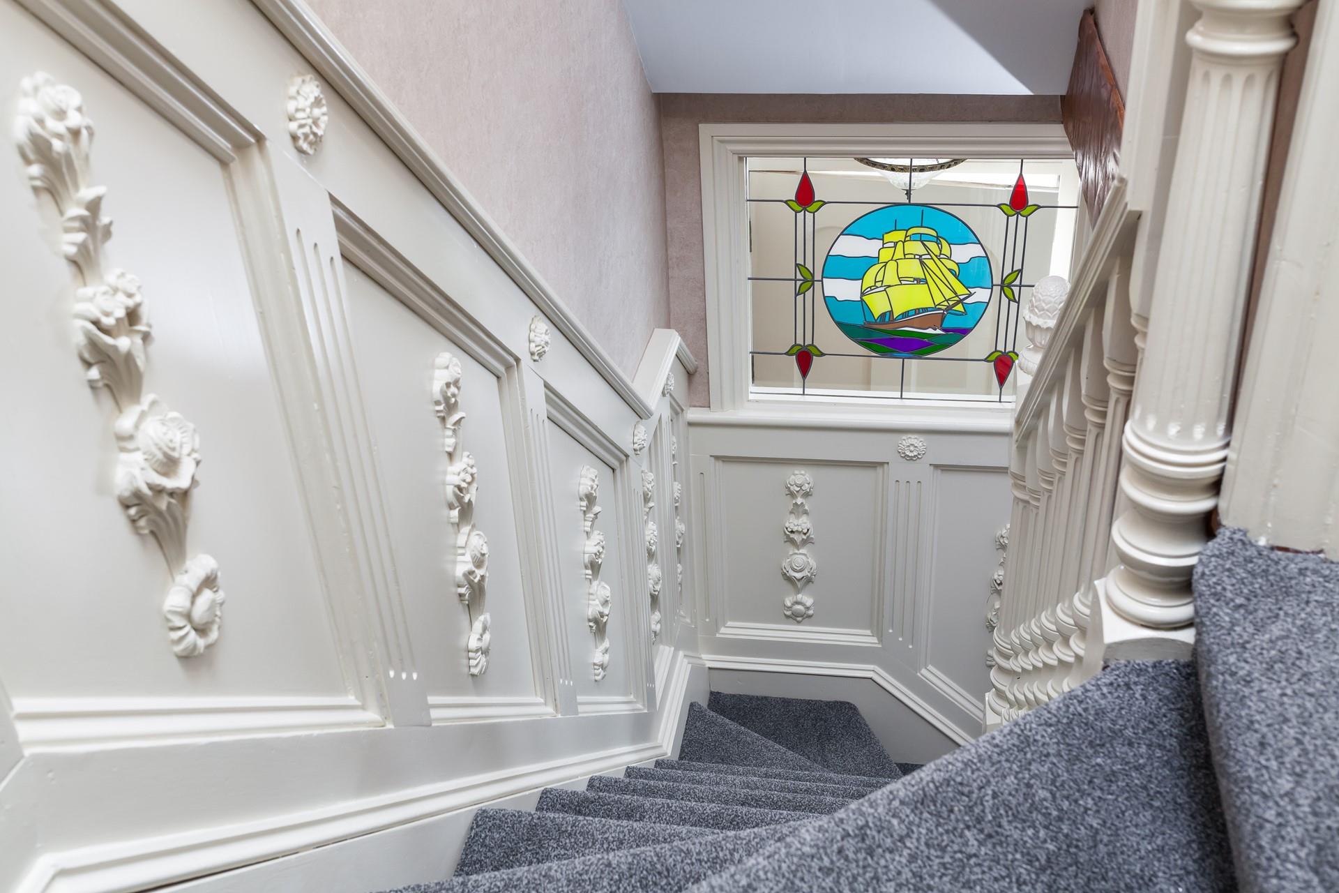 We love the beautiful stained glass window at the bottom of the stairs.
