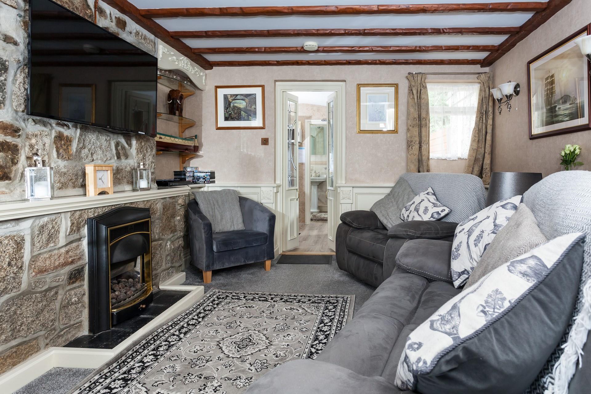 The comfortable sitting room includes a gas flame effect fire to keep you cosy in the evenings. 