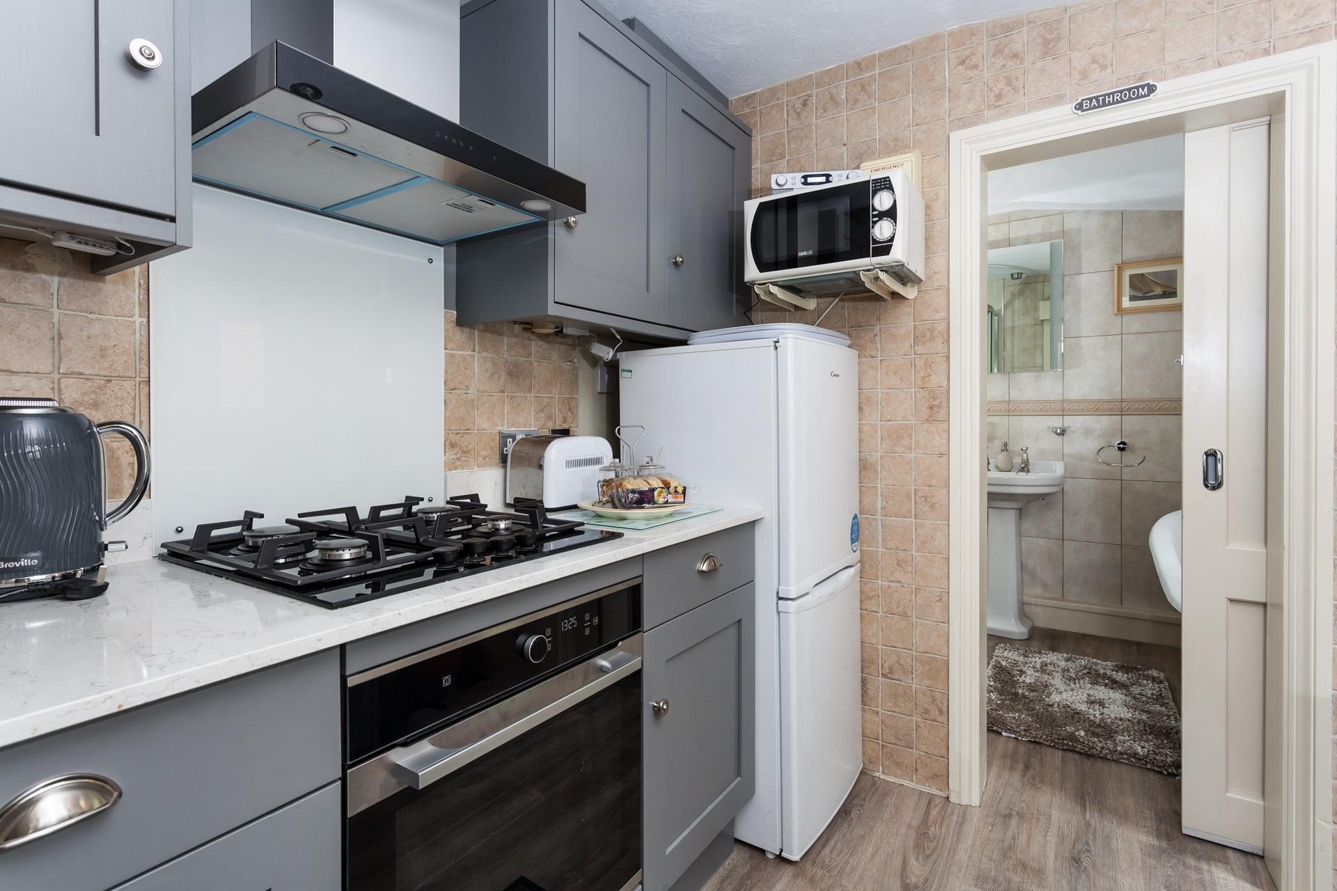 The recently refurbished kitchen is well-equipped for all your cooking needs.