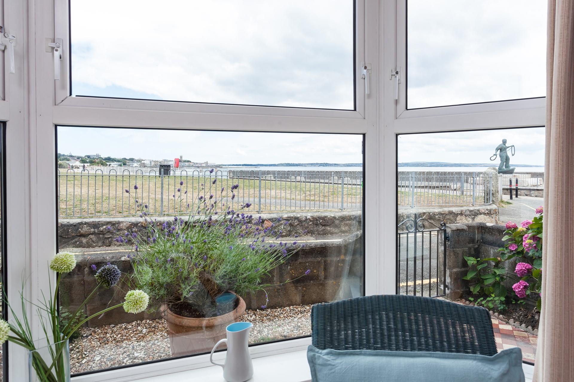 The living room has fantastic views towards Penzance and across Mounts Bay.