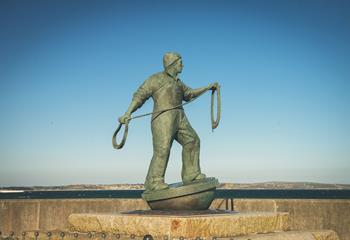 A local statue of a fisherman, a few paces from the house. 