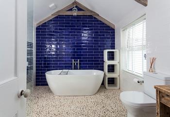 A luxurious bathing experience can be had in the spacious bathroom.