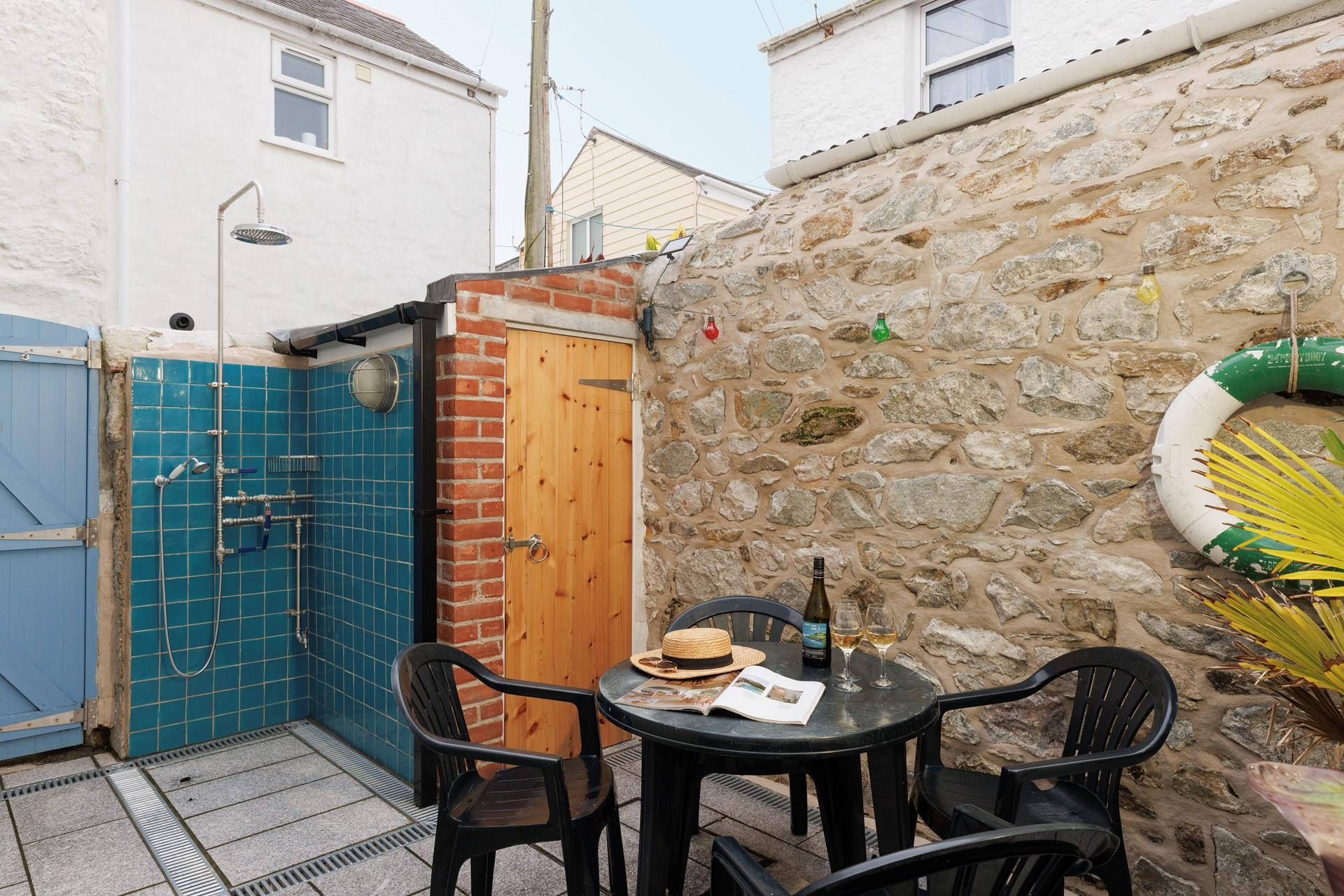 There is a decked outside area with a table and chairs.