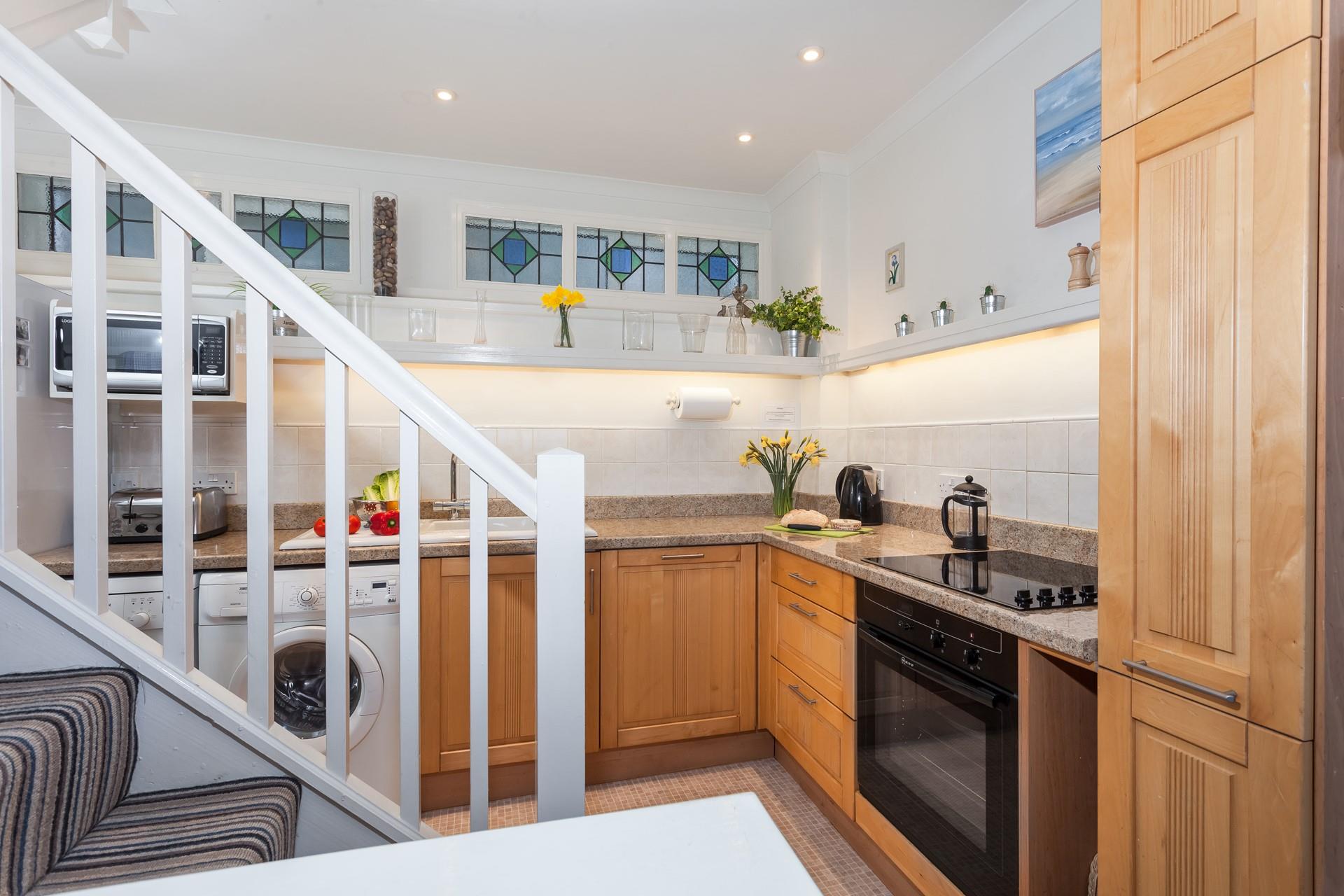 The kitchen features beautiful stained glass and is well-equipped for all your cooking needs.