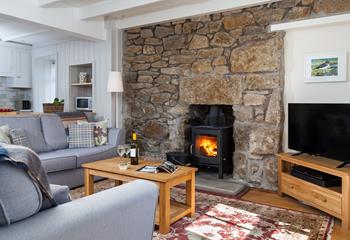 This charming cottage is finished with comfy sofas and a woodburner creating a homely getaway. 