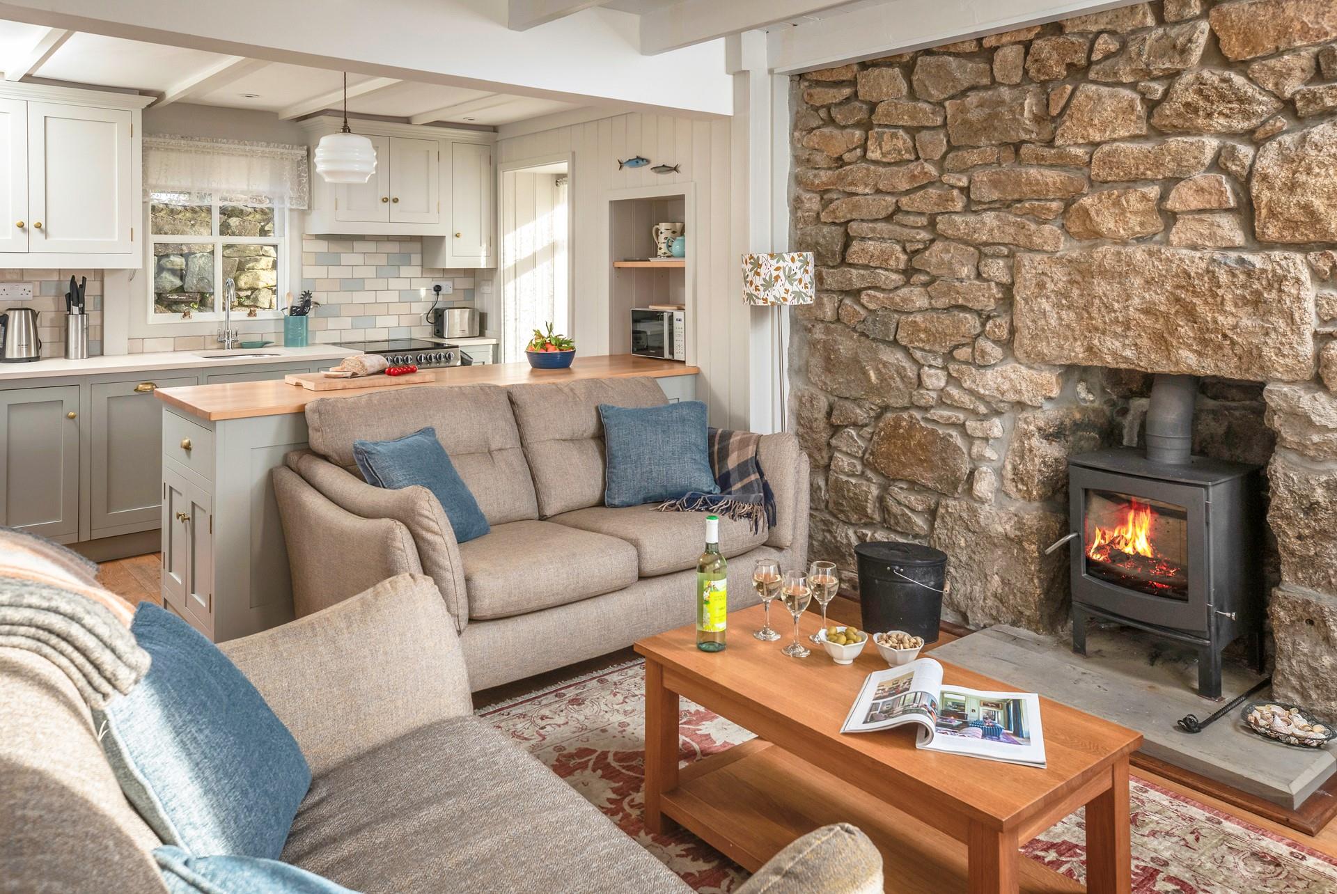 This charming cottage is finished with comfy sofas and a woodburner creating a homely getaway. 