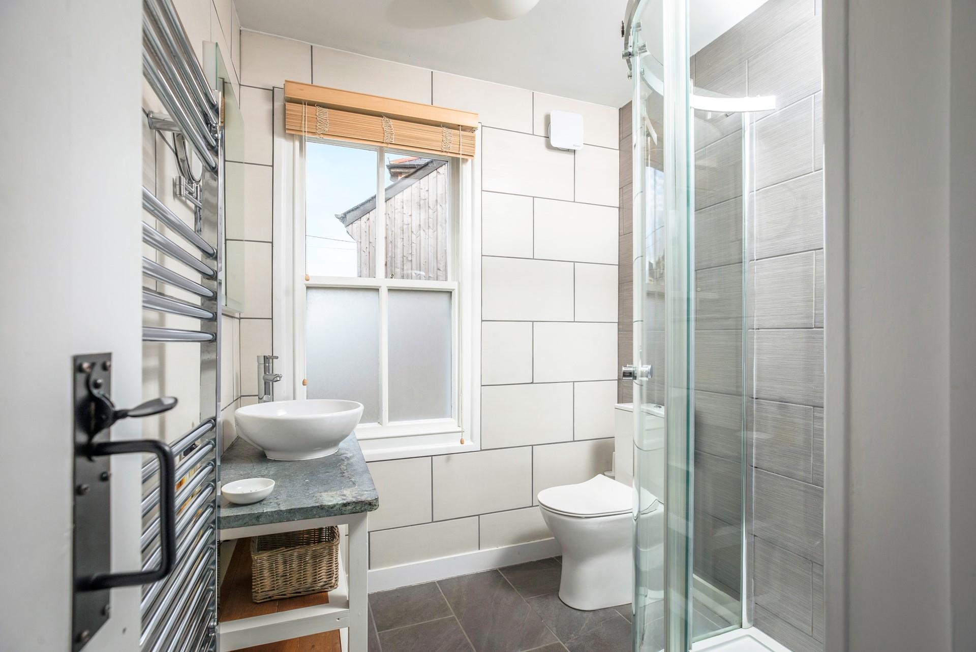 Underfloor heating keeps the family shower room nice and cosy.